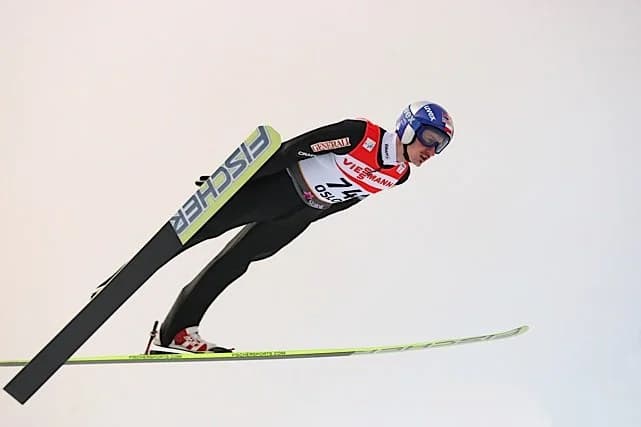 Adam Malysz mid-flight during a ski jumping competition in Oslo, 2011