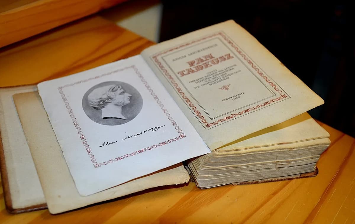 Vintage printed edition of Pan Tadeusz by Adam Mickiewicz, open to the title page with the author's portrait and signature