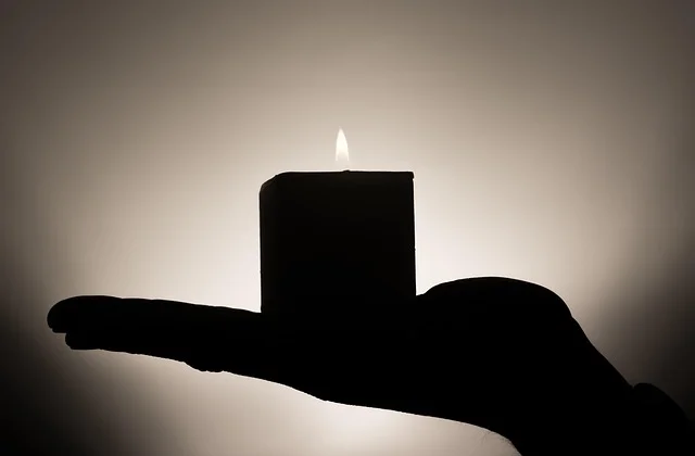 Candlelit shadow reading during a Polish andrzejki wax-pouring party