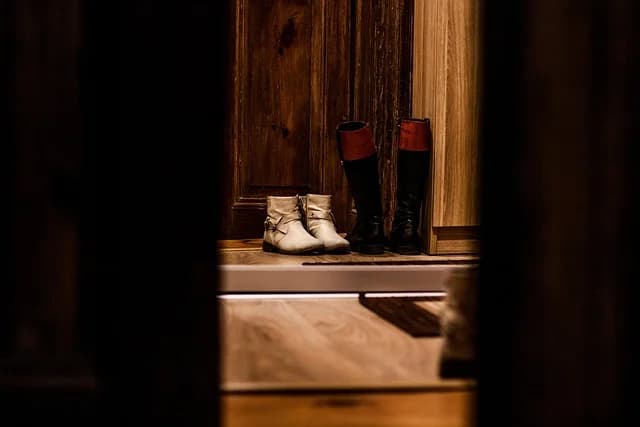 Row of shoes lined up for the andrzejki polish tradition shoe race toward a doorway