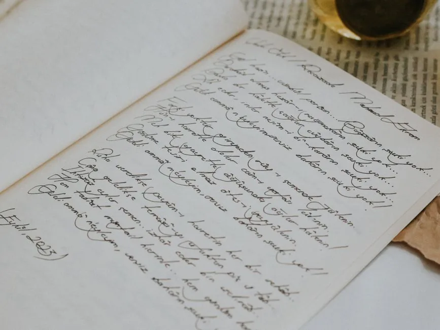 Open notebook with grammar tables and handwritten language notes — Photo by betül nur akyürek on Pexels