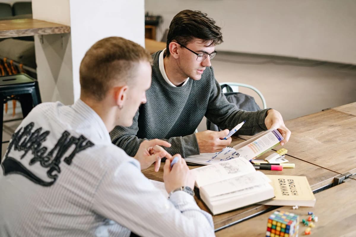 Two students studying Polish grammar books together — Photo by Ivan S on Pexels