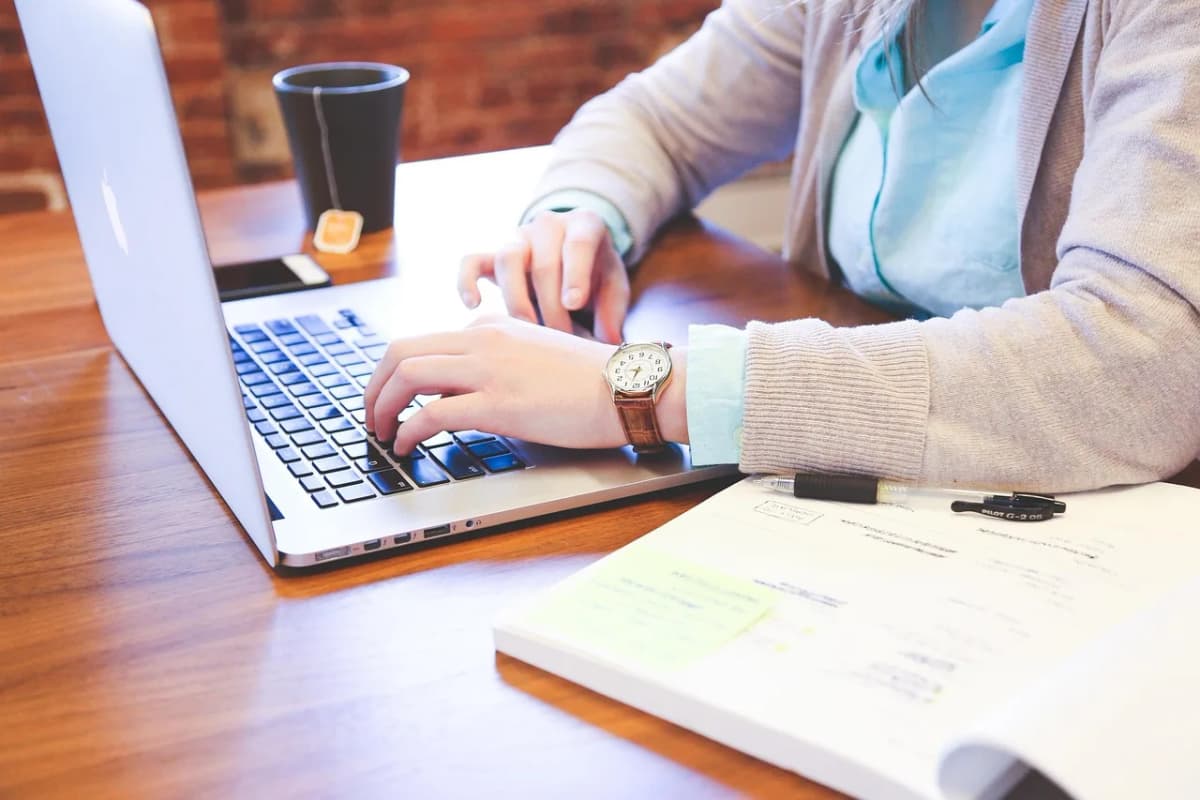 A student working on a laptop at a café table