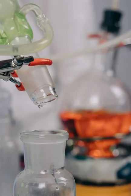 Laboratory glassware with tubes and a flask over a heat source