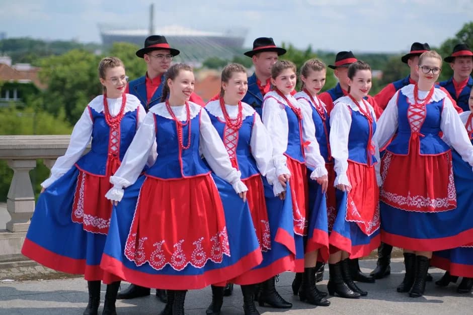 Polish folk motifs in traditional costume — dancers in blue and red folk dress near Kraków