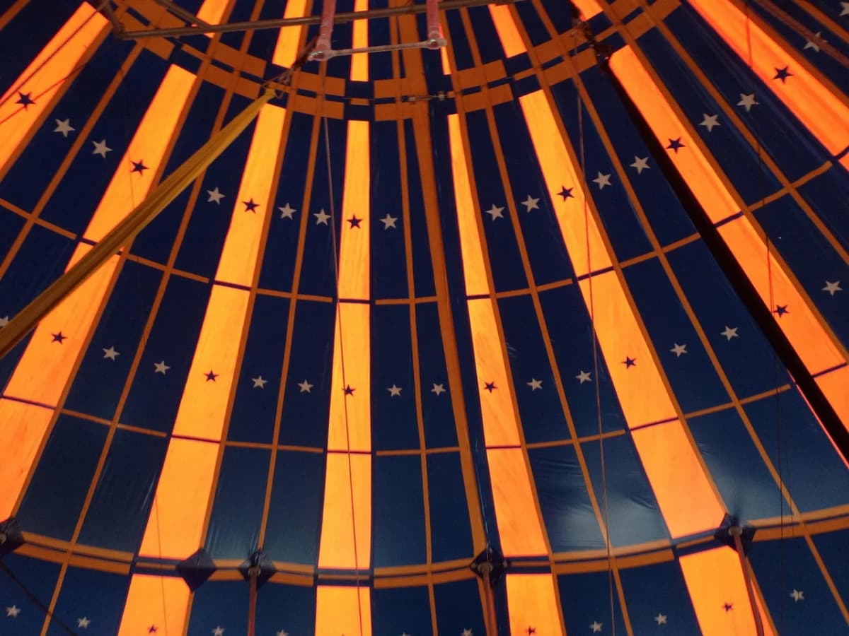Colorful striped big top circus tent, symbolizing the famous funny Polish idioms line not my circus not my monkeys