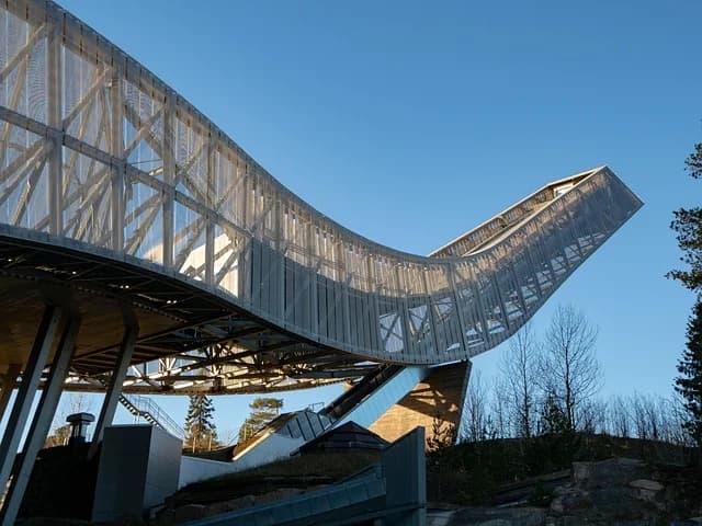 A modern ski jumping hill structure, representing the sport Kamil Stoch competed in for over two decades