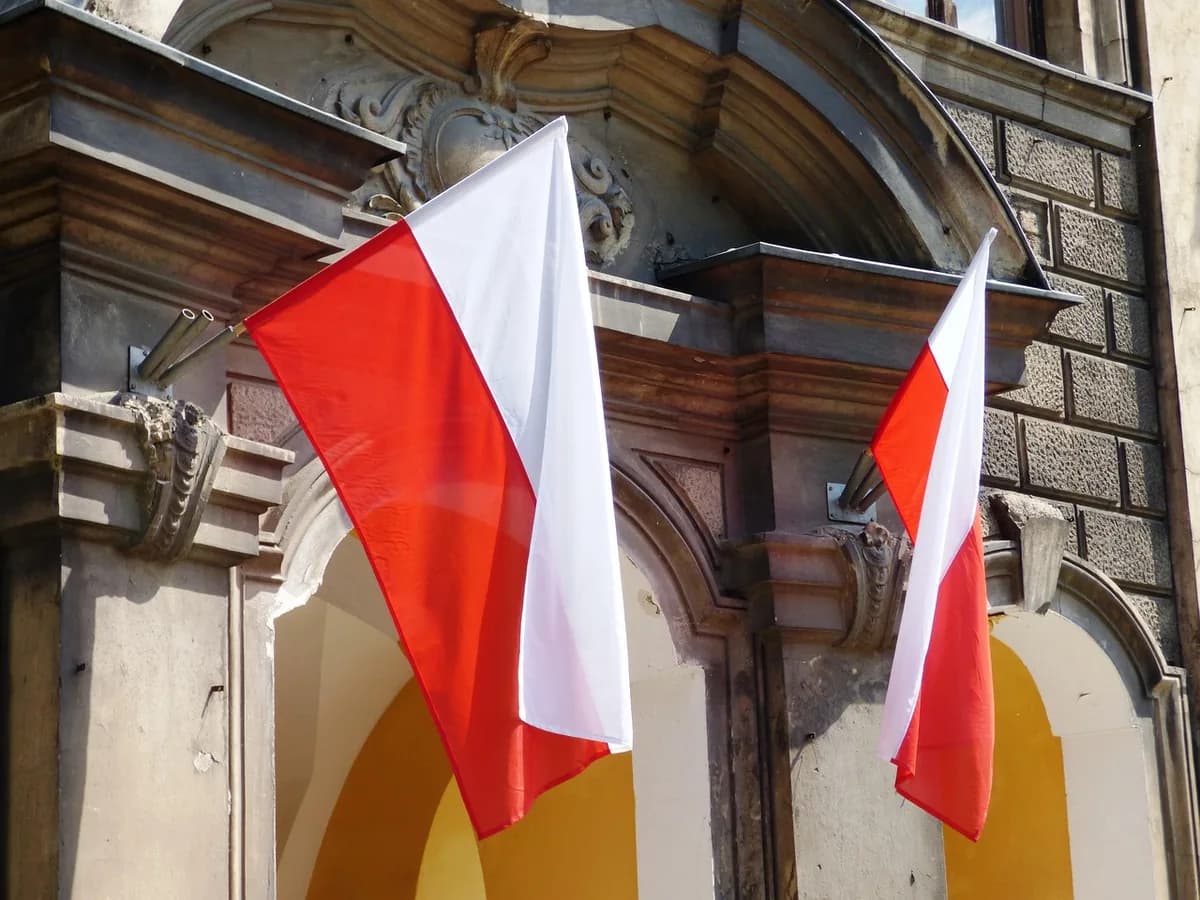 The Polish flag hanging on a government building facade, representing where you'd apply for a PESEL number