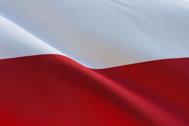 A close-up of the Polish flag, its red and white folds catching the light