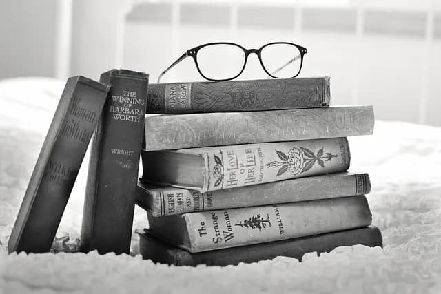 A stack of old hardcover books, evoking the underground schooling that kept Polish literacy alive under occupation