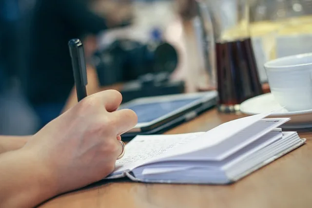 Open notebook and pen, representing the process of learning Polish verb aspect