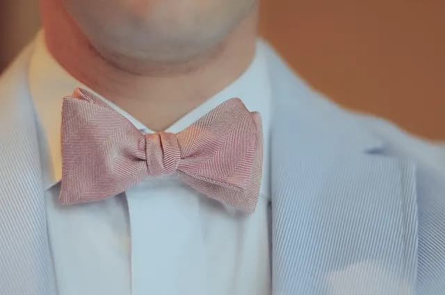 Close-up of a formal bow tie worn with a suit, part of the traditional studniówka dress code