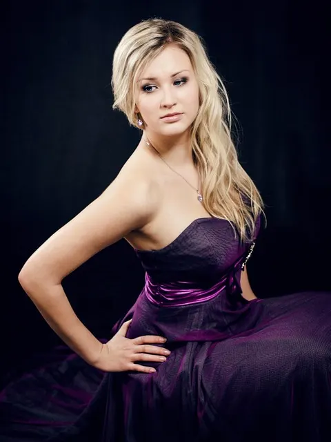 An elegant woman in a formal evening gown, the kind of outfit worn to a studniówka ball