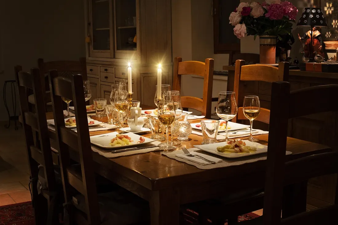 A festive dinner table set with glasses and food ready for a New Year's Eve celebration