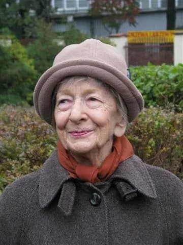 Wislawa Szymborska smiling and wearing a hat, photographed in Krakow in 2009