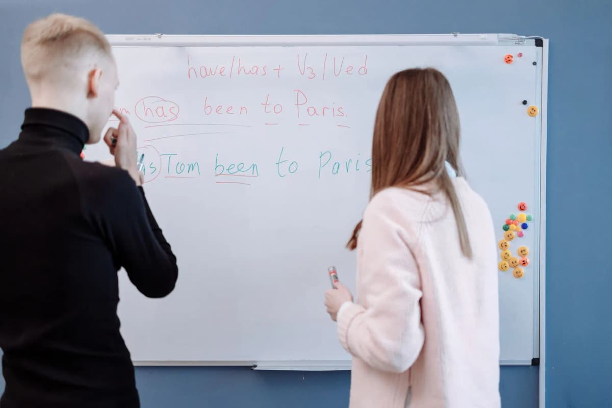 Students studying verb conjugation at a whiteboard — Photo by Thirdman on Pexels