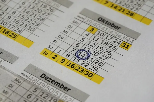 A printed wall calendar showing a full month grid with one date circled — the kind of calendar you'd use to practice days and months in Polish
