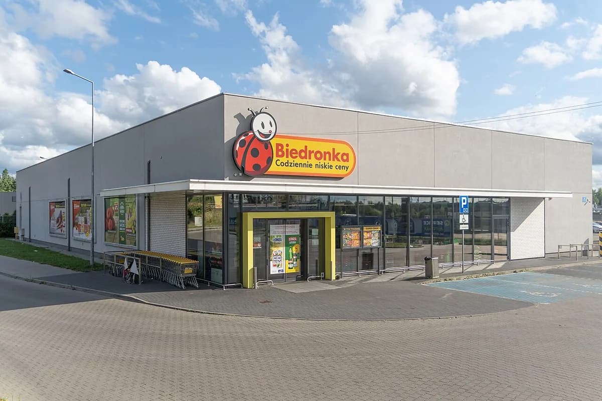 The exterior of a Biedronka supermarket in Sosnowiec, Poland, showing the red ladybird logo and the tagline Codziennie niskie ceny