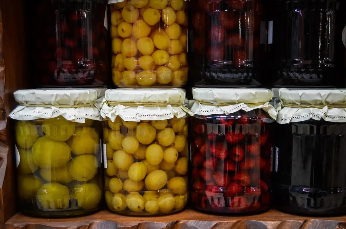 Jars of homemade fruit compote and preserves, similar to how kompot is bottled and stored