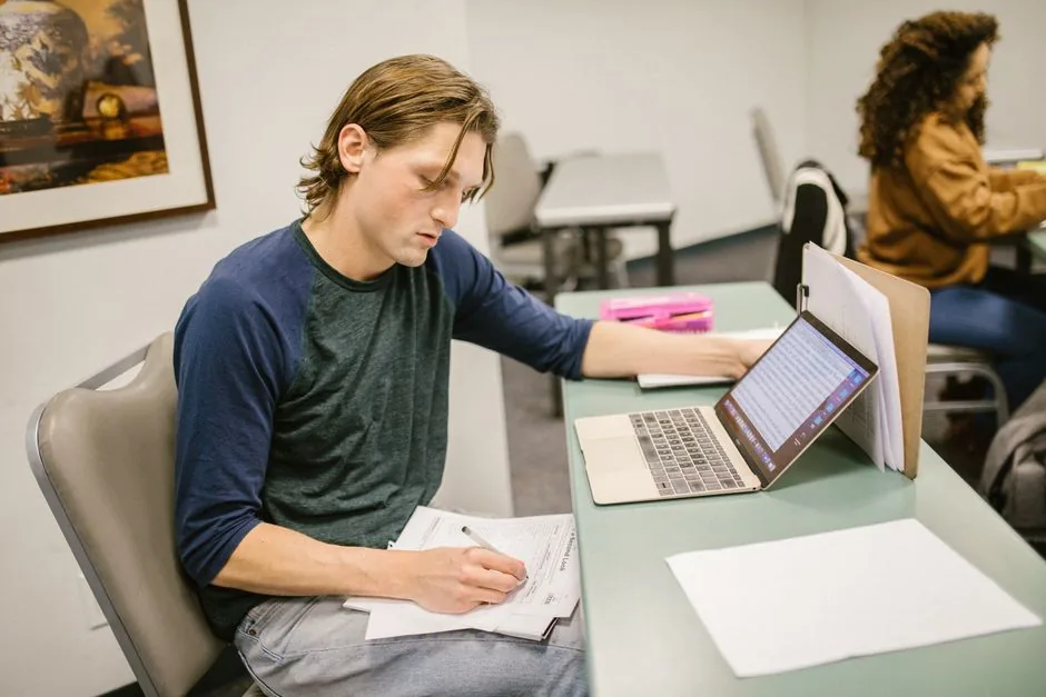 Student studying notes on a laptop comparing two options — Photo by RDNE Stock project on Pexels