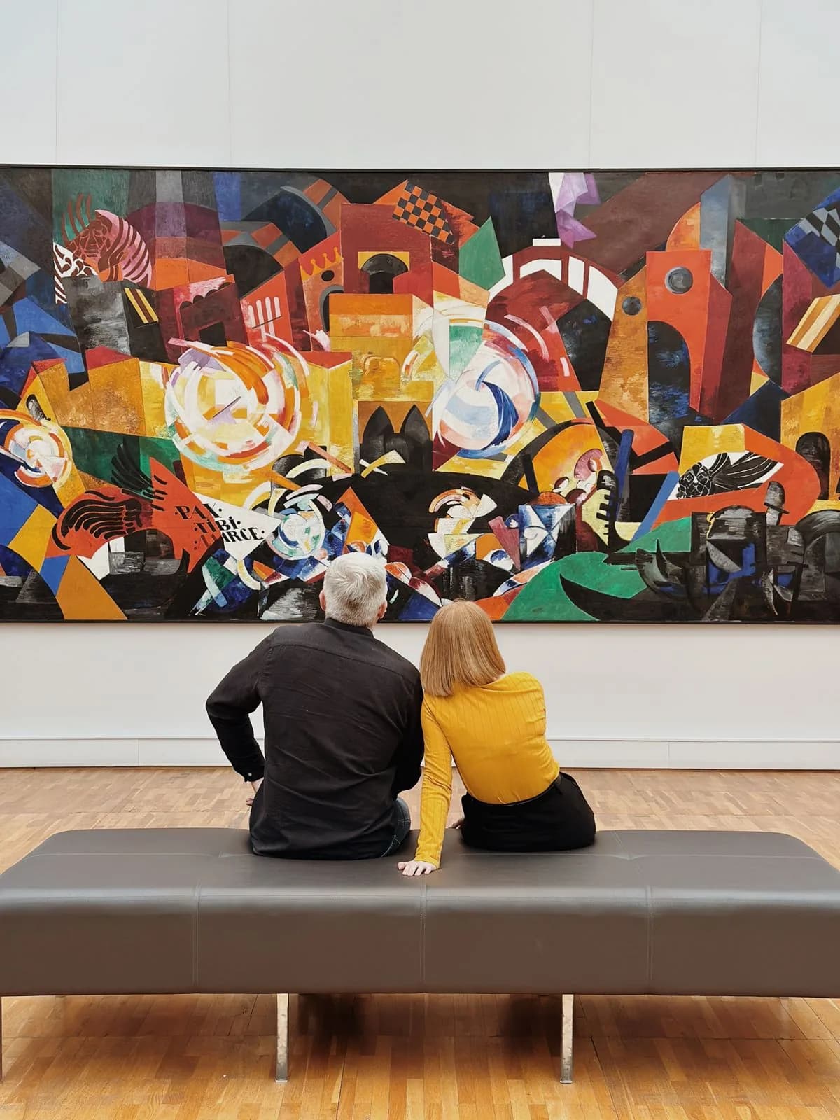 Visitors exploring an art gallery with paintings on display — Photo by N/A on Pexels