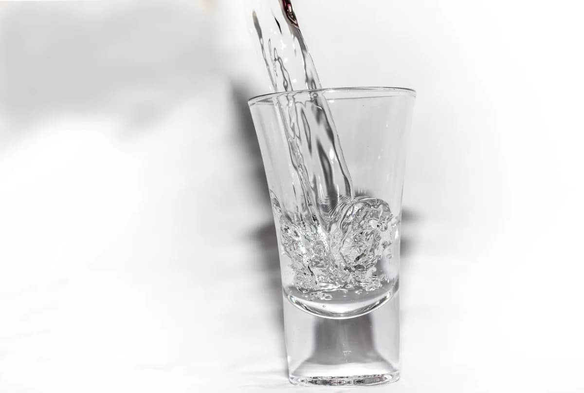 Żubrówka-style vodka being poured into a shot glass