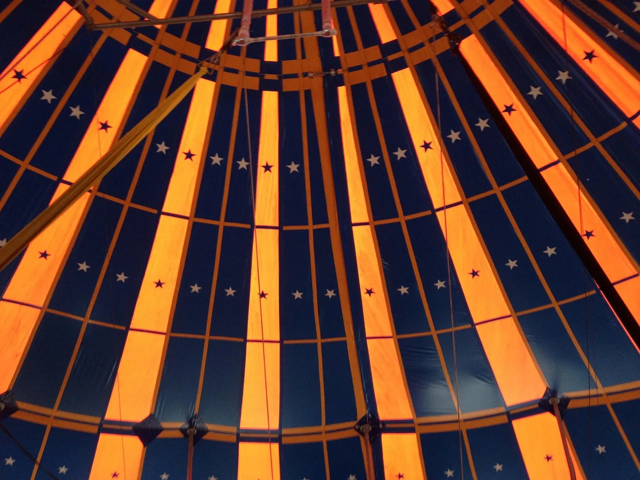 Colorful striped big top circus tent, symbolizing the famous funny Polish idioms line "not my circus, not my monkeys"