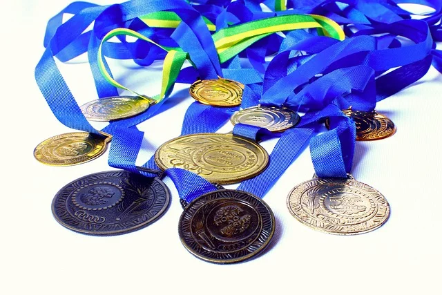 A collection of medals on ribbons, representing Kamil Stoch's three individual Olympic gold medals