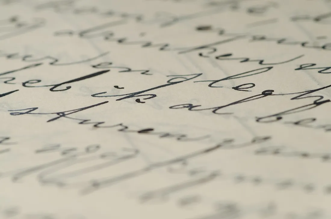A close-up of ornate handwritten cursive script on aged paper
