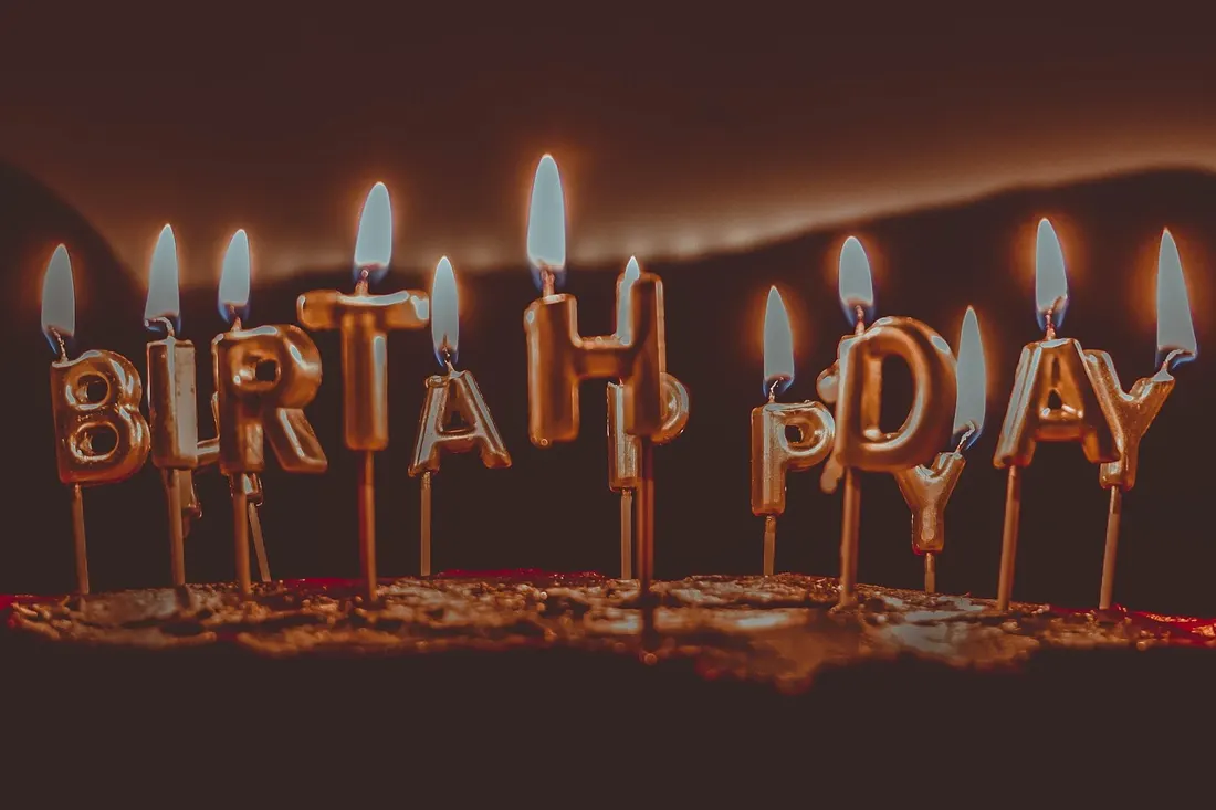 Birthday candles aglow — a familiar cue for the sto lat song to begin