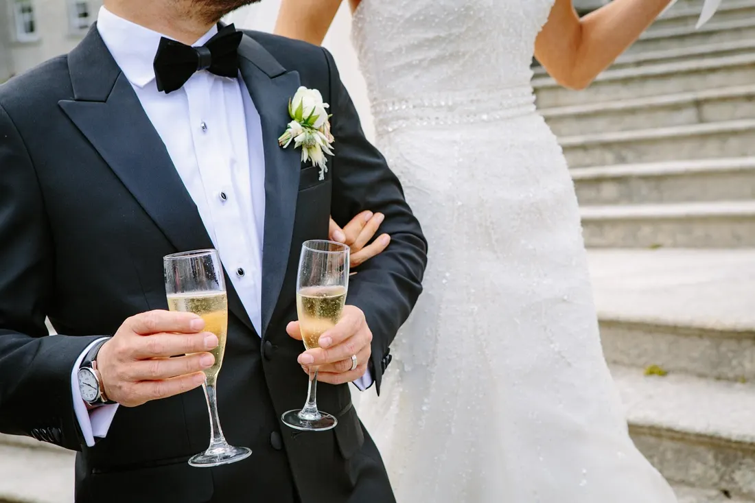 A couple toasting with champagne at their wedding reception, the kind of moment when guests sing the sto lat song in Poland