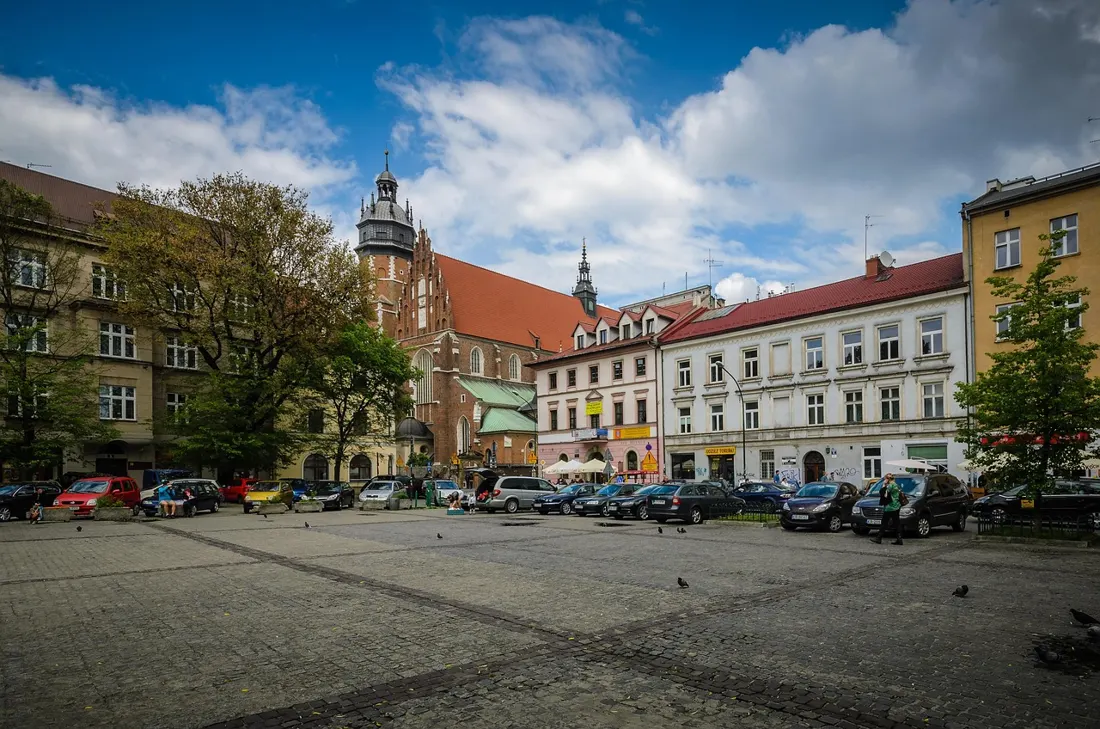 The cobblestone square of Kazimierz in Kraków's old Jewish quarter, home to Plac Nowy and its famous zapiekanka stands